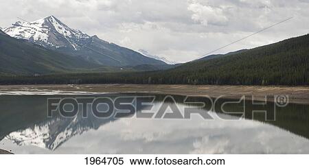 Stock Photography - The Mountains Reflected Into A Lake; Jasper Alberta Canada. Fotosearch