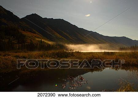 Stock Image - The Mountains Surrounding Annie Lake In Full Moonlight Near Whitehorse, Yukon, Canada. Fotosearch
