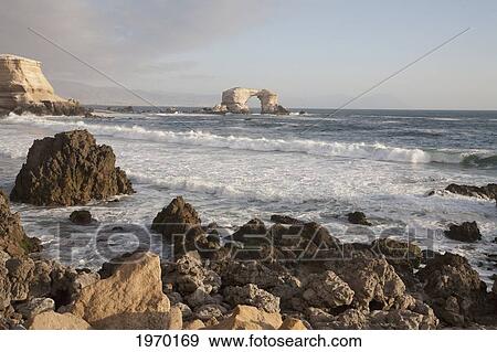 Stock Photo - The Natural Monument Of La Portada De Antofagasta, As Seen From The Surrounding Sandstone Cliffs, Antofagasta Region, Chile. Fotosearch