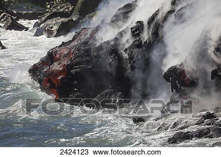 Stock Image - The Pahoehoe lava flowing from Kilauea has reached the Pacific ocean near Kalapana; Island of Hawaii, Hawaii, United States of America. Fotosearch