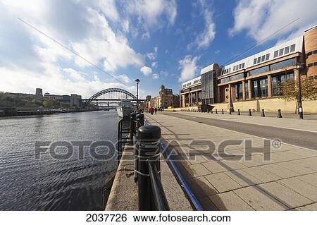 Stock Photograph - The Promenade And Tyne Bridge Crossing The River Tyne; Newcastle Northumberland England. Fotosearch