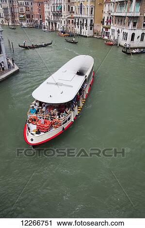 Stock Image - The public transport boat on the Grand Canal; Venice, Italy. Fotosearch