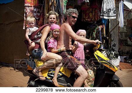 The Reynolds family on holiday in Goa transport the family Indian style 5-up on a moped, Patnum Beach, Goa, India. View Large Photo Image Stock Photo - The Reynolds family on holiday in Goa transport the family Indian style 5-up on a moped, Patnum Beach, Goa, India.. Fotosearch