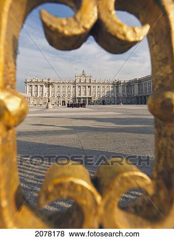 The Royal Palace As Seen Through Gold Painted Details Of A Metal Fence; Madrid Spain View Large Photo Image Stock Photo - The Royal Palace As Seen Through Gold Painted Details Of A Metal Fence; Madrid Spain. Fotosearch