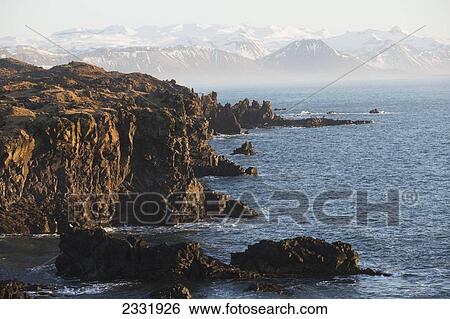 The Rugged Coastline Of The Southern Snaefellness Peninsula; Arnarstapi, Iceland View Large Photo Image Stock Photograph - The Rugged Coastline Of The Southern Snaefellness Peninsula; Arnarstapi, Iceland. Fotosearch