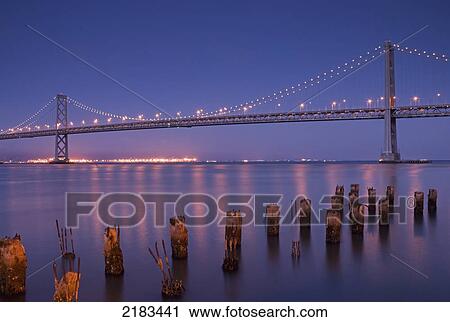Stock Image - The San Francisco Bay Bridge At Night; San Francisco California United States Of America. Fotosearch