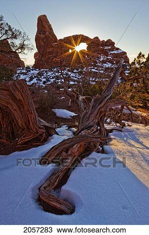 Stock Image - The Setting Sun Seen Through Turret Arch, Arches National Park, Utah.. Fotosearch