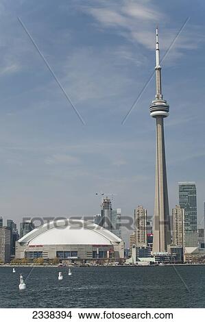Picture - The Skydome And Cn Tower From Lake Ontario With Blue Sky And Clouds; Toronto, Ontario, Canada. Fotosearch