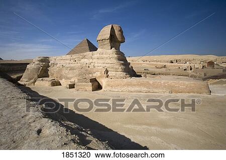 Stock Image - The Sphinx With The Pyramid In Background. Fotosearch