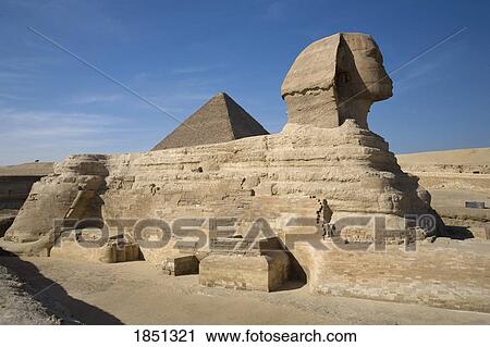 Stock Image - The Sphinx With The Pyramid In Background; Cairo, Egypt, Africa. Fotosearch