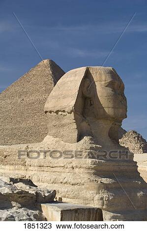 Stock Image - The Sphinx With The Pyramid In Background. Fotosearch