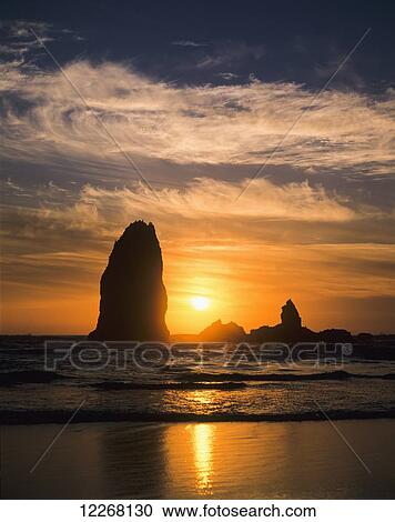 The sun sets along the Oregon coast; Cannon Beach, Oregon, United States of America View Large Photo Image Stock Image - The sun sets along the Oregon coast; Cannon Beach, Oregon, United States of America. Fotosearch