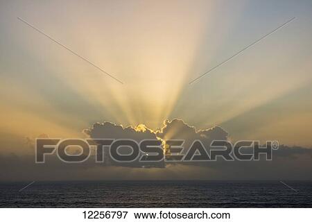Stock Photo - The sun sets in the clouds at Oswald West State Park; Manzanita, Oregon, United States of America. Fotosearch
