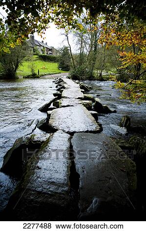 Stock Photo - The Tarr Steps, a prehistoric clapper bridge across the River Barle, Exmoor National Park; Somerset, England. Fotosearch