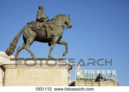 Stock Image - The Tio Pepe Sign And Equestrian Statue Of Carlos Iii Puerta Del Sol; The Tio Pepe Sign And Equestrian Statue Of Carlos Iii, Puerta Del Sol, Madrid, Spain, Europe. Fotosearch