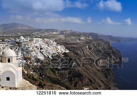 Stock Photograph - The town of Fira, the capital of the island of Santorini (classically Thera, officially Thira) in the Cyclades island group of Greece; Fira, Island of Santorini, Greece. Fotosearch