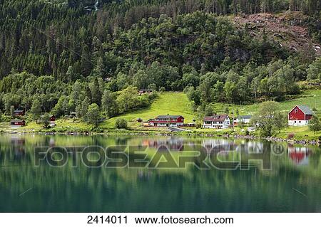 The tranquil water of Nordfjorden reflecting the trees, houses and barn; Olden, Norway View Large Photo Image Stock Image - The tranquil water of Nordfjorden reflecting the trees, houses and barn; Olden, Norway. Fotosearch
