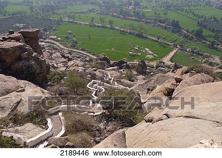 Stock Photograph - The Walk Up To Yantrodharaka Anjaneya Temple, Or Hanuman Temple, On Top Of Anjaneya Hill At Hampi, Karnataka, India. Fotosearch