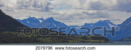 Stock Photograph - The White Pass And Yukon Route Train Winds Its Way Along The Shores Of Bennett Lake, Yukon. Outside Of Carcross, Yukon.. Fotosearch