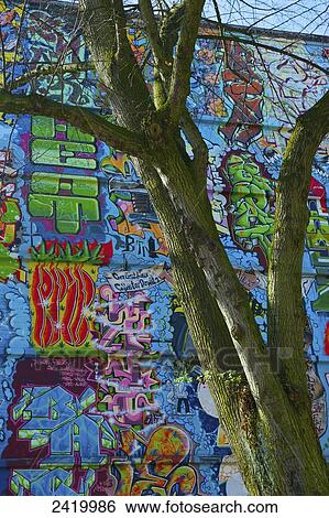 The whole surface of an exterior wall of a building covered in colourful graffiti; Hamburg, Germany View Large Photo Image Stock Photograph - The whole surface of an exterior wall of a building covered in colourful graffiti; Hamburg, Germany. Fotosearch