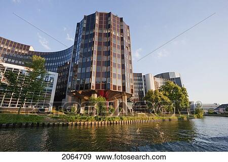 Stock Photo - The Winston Churchill Building Of The European Parliament On The Banks Of The Ill River, Strasbourg, France. Fotosearch