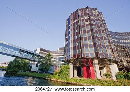 Stock Photo - The Winston Churchill Building Of The European Parliament On The Banks Of The Ill River, Strasbourg, France. Fotosearch