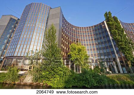 Stock Photo - The Winston Churchill Building Of The European Parliament On The Banks Of The Ill River, Strasbourg, France. Fotosearch