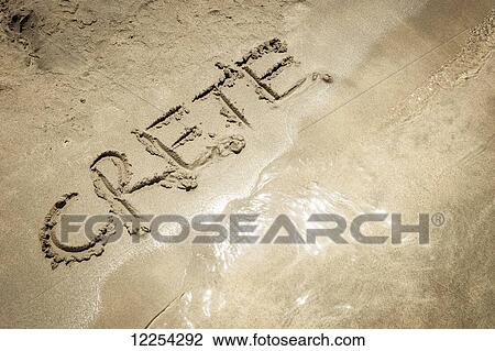 Stock Image - The word crete written in the sand at the water's edge, Elafonisi beach; Crete, Greece. Fotosearch