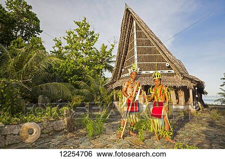 These two young boys in traditional outfits for cultural ceremonies are standing in front of a Men's House; Yap, Micronesia View Large Photo Image Stock Photograph - These two young boys in traditional outfits for cultural ceremonies are standing in front of a Men's House; Yap, Micronesia. Fotosearch