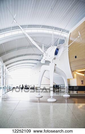 Stock Photo - This giant, three-legged, glossy white Space Observer is a piece of art created by artist Bjorn Schulke for the San Jose International airport; San Jose, California, United States of America. Fotosearch