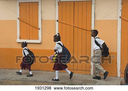 Stock Photo - Three Children Walking To School; Carriacou Island In The Grenadines. Grenada. Caribbean.. Fotosearch