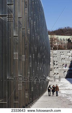 Stock Image - Three Female Students Walking Towards Their Class At Ehwa Women's University; Seoul, South Korea. Fotosearch