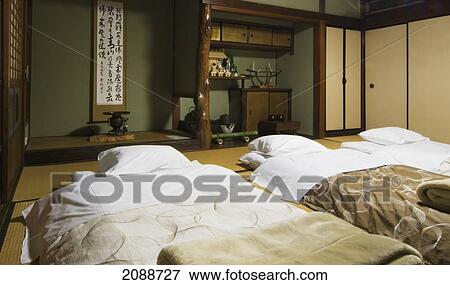 Stock Photo - Three Futons Beds Ready For The Night In A Traditional Japanese Home; Nara, Japan. Fotosearch