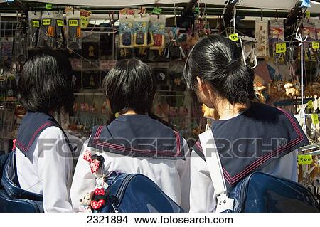 Picture - Three girls looking at wares on display at Teapot Lane; Kyoto, Japan. Fotosearch