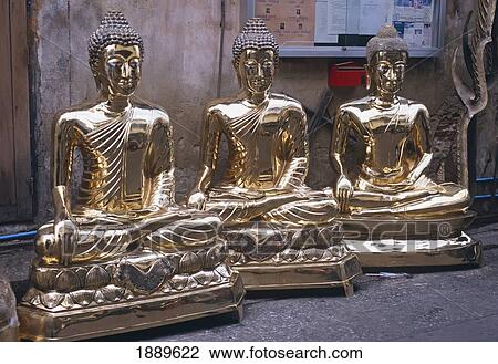 Stock Image - Three Golden Buddha Statues Lined Up. Fotosearch