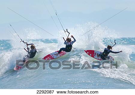 Stock Photo - Three kitesurfers in water; Tarifa, Cadiz Province, Andalusia, Spain. Fotosearch