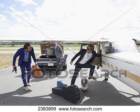 Three musicians transferring from car to plane; Langley, British Columbia, Canada View Large Photo Image Stock Photo - Three musicians transferring from car to plane; Langley, British Columbia, Canada. Fotosearch