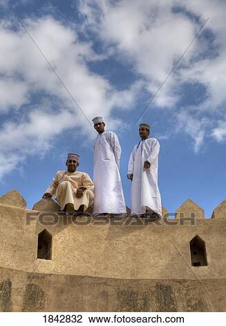 Three Omani Men On The Top Of Rustaq Fort; Rustaq, Oman View Large Photo Image Stock Image - Three Omani Men On The Top Of Rustaq Fort; Rustaq, Oman. Fotosearch