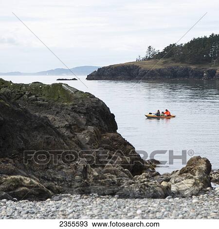 Stock Image - Three People In A Boat Off The Shores Of Deception Pass State Park; Washington, United States Of America. Fotosearch