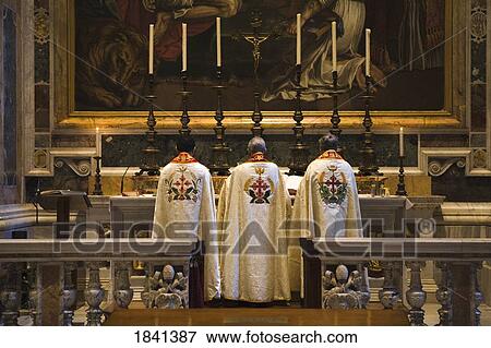 Stock Photo - Three Priest Standing At Altar In Saint Peter's Basilica; Vatican City, Rome, Italy. Fotosearch