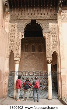 Stock Image - Three Tourists Watching Saadian Tombs. Fotosearch