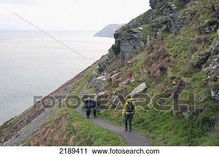 Three Walkers Along The South West Coast Path Near Lynmouth, Exmoor, United Kingdom View Large Photo Image Stock Image - Three Walkers Along The South West Coast Path Near Lynmouth, Exmoor, United Kingdom. Fotosearch