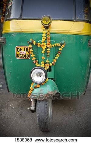 Stock Photo - Three-Wheel Indian Taxi Decorated With Flowers; Delhi, India. Fotosearch