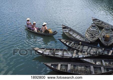 Three Women In Boat Wearing Conical Hats View Large Photo Image Stock Image - Three Women In Boat Wearing Conical Hats. Fotosearch