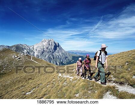 Three Women Walking Along Ridge In Front Of Corno Grande In The Campo Imperatore View Large Photo Image Stock Photography - Three Women Walking Along Ridge In Front Of Corno Grande In The Campo Imperatore. Fotosearch