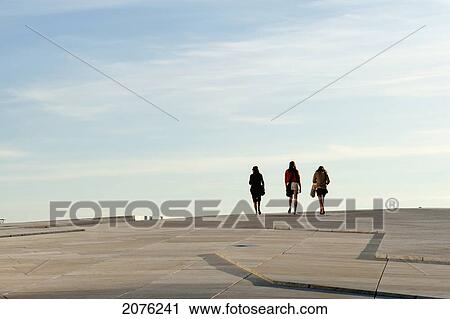 Stock Image - Three Women Walking Together By Oslo Opera House; Oslo Norway. Fotosearch