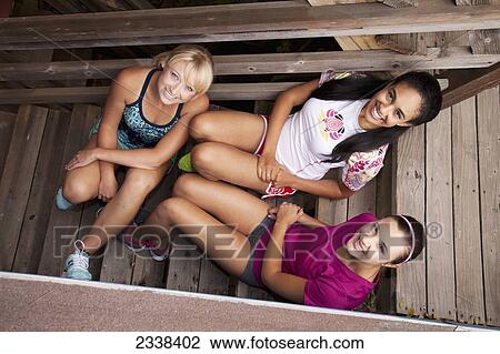 Three Young Female Friends Sitting On Wooden Steps; California, Usa View Large Photo Image Stock Image - Three Young Female Friends Sitting On Wooden Steps; California, Usa. Fotosearch