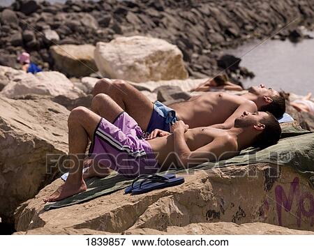 Three Young Man Lying On Shore Rocks; Naples, Italy View Large Photo Image Stock Photo - Three Young Man Lying On Shore Rocks; Naples, Italy. Fotosearch