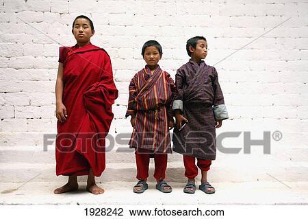 Stock Image - Three Young Monks, Punakha, Bhutan. Fotosearch