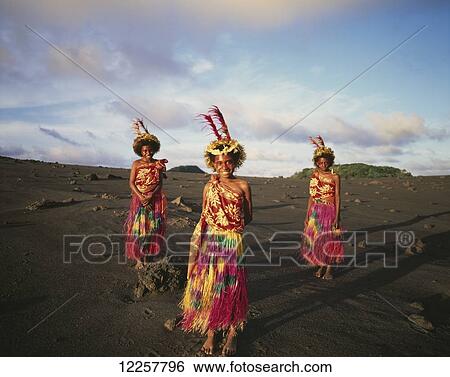 Stock Photograph - Three young woman standing on the lava fields of Yasur Volcano; Tanna Island, Vanuatu. Fotosearch